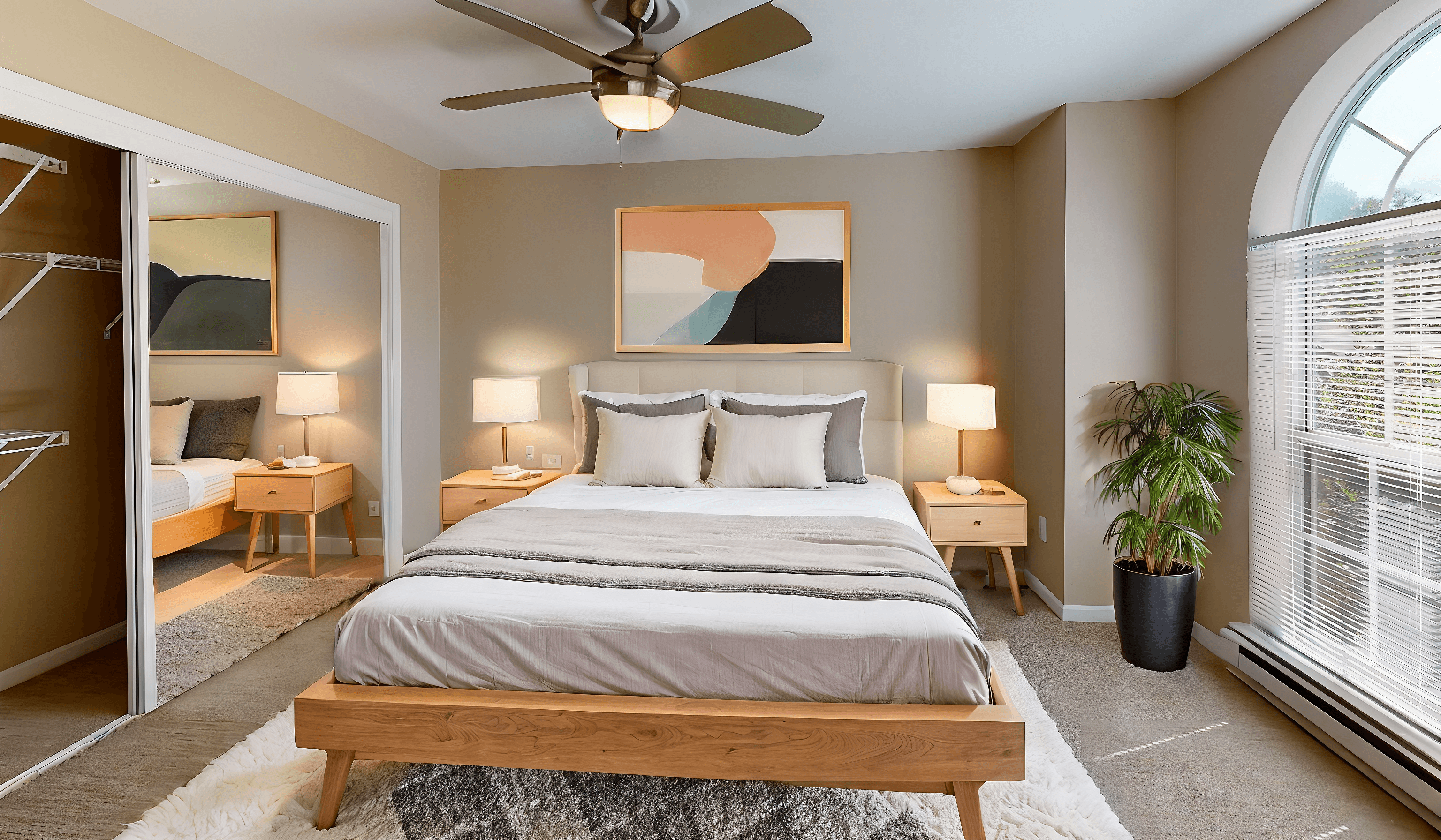 a bedroom with a large bed and a ceiling fan